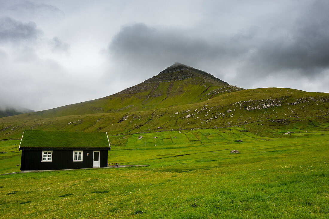 Lonely grass roofed house in Gjogv, Estuyroy, Faroe islands, Denmark