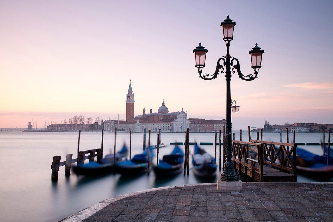 Blick in Richtung San Giorgio Maggiore in der Morgendämmerung von Riva Degli Schiavoni, mit Gondeln im Vordergrund, Venedig, UNESCO Weltkulturerbe, Veneto, Italien, Europa