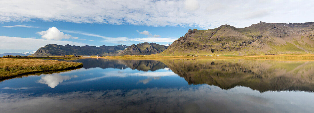 Panoramic view of mountains and blue sky reflecting in lake, near Vik, South Iceland, Polar Regions