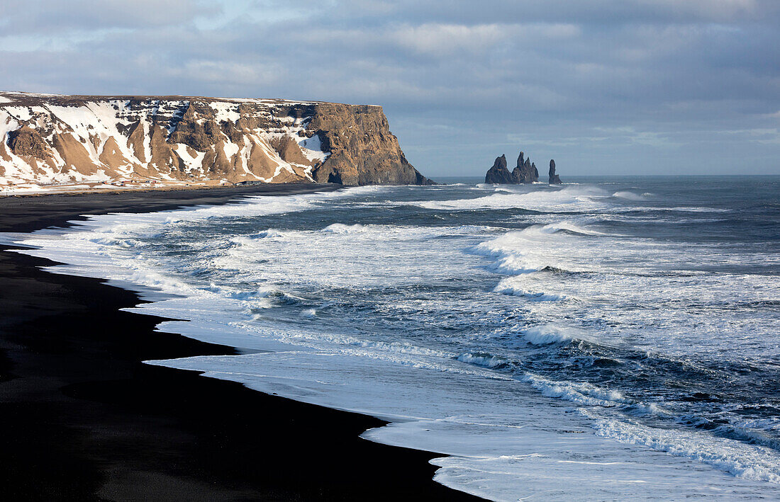 Winter view across the North Atlantic from Dyrholaey towards Reynisdrangar, near Vik, South Iceland, Polar Regions