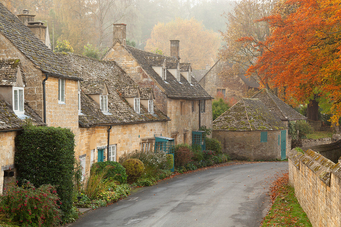 Line of Cotswold stone cottages in autumn mist, Snowshill, Cotswolds, Gloucestershire, England, United Kingdom, Europe