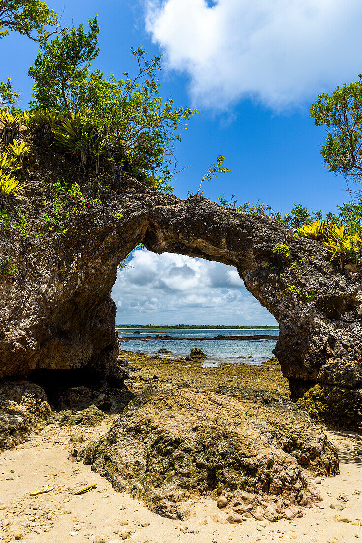 Hole in rock carved by wind at Pedra Furada Island in tropical South Bahia, Peninsula de Marau, Brazil