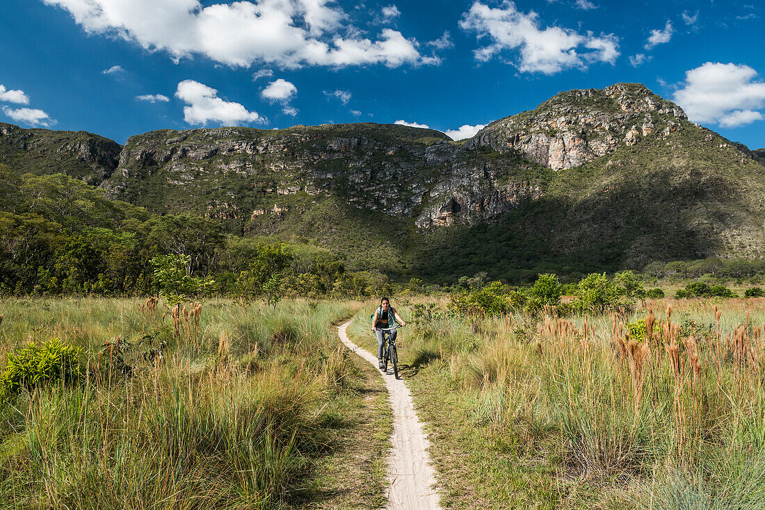 Woman riding adventure bike in Serra do Cipo National Park, Minas Gerais, Brazil