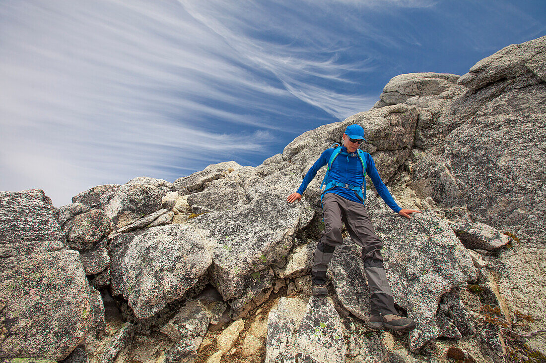 Photograph of backpacker descending rocks at Needle Peak, Hope, British Columbia, Canada
