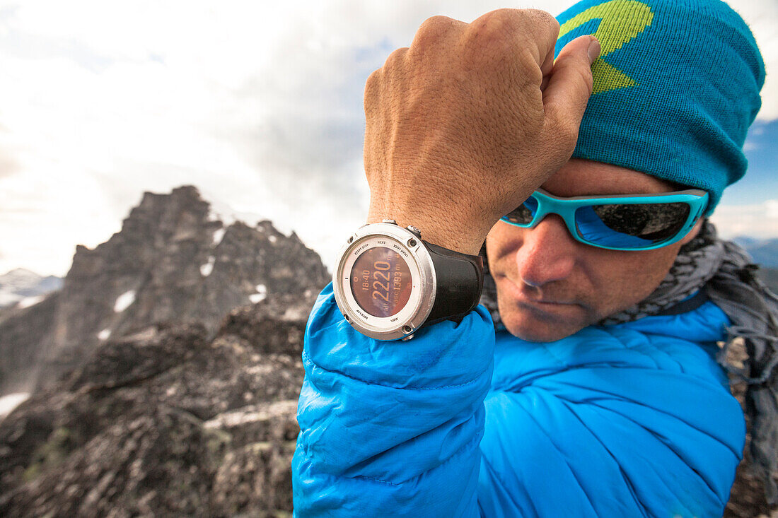 Photograph of mountain climber showing smart watch with summit elevation, Chilliwack, British Columbia, Canada