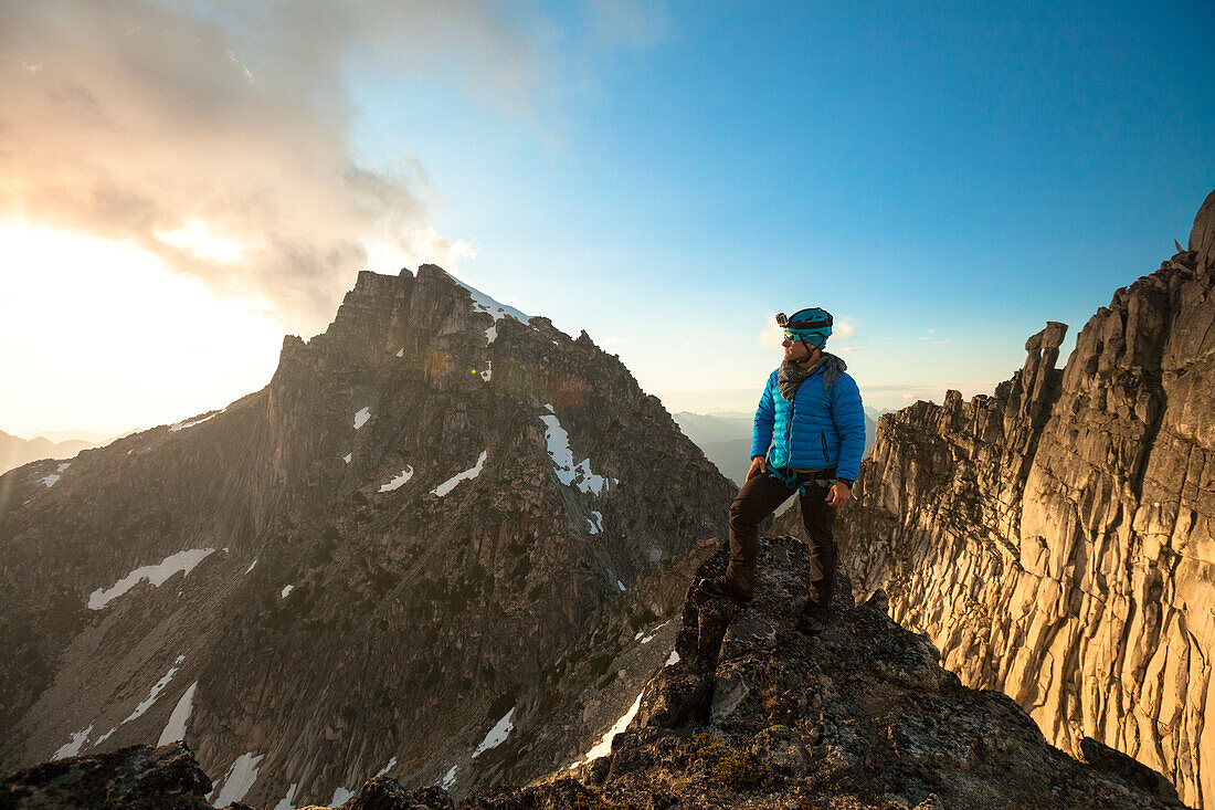 Photograph of mountain climber looking at view at sunset, Chilliwack, British Columbia, Canada