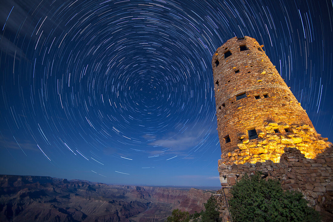 Scenic view with tower at southern rim of Grand Canyon under star trails at night, Arizona, USA