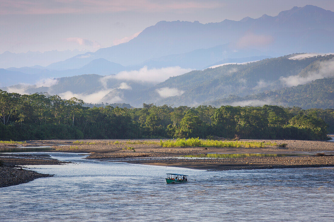 Ansicht des Alto (oberen) Flusses Madre De Dios in Peru. Umgeben von Dschungel, mit Boot im Morgenlicht und Wolken.