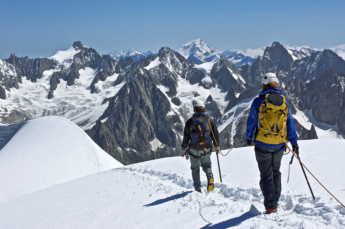 Climbers make their way along a ridge near the Aiguille du Midi on Mont Blanc in the French Alps of Chamonix, France