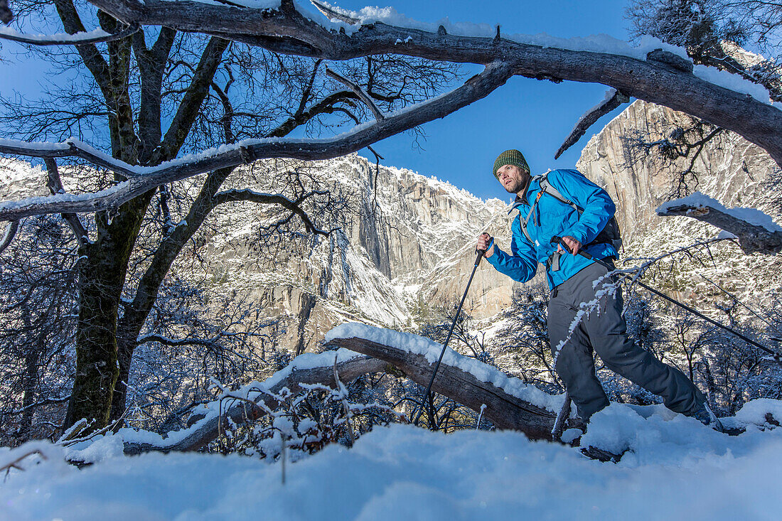 Photograph of man hiking in High Sierras in winter, California, USA