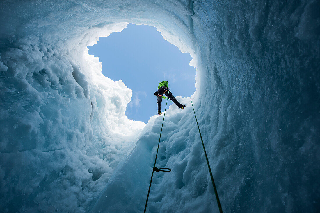 Fotografie des abenteuerlichen Mannes, der in Moulin in Coleman Gletscher, Mount Baker, Washington State, USA abseilt.