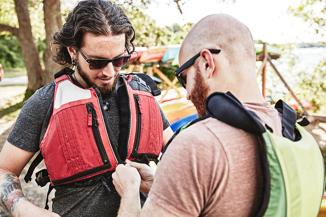 Photograph of kayaker helping another put on life vest, Portland, Maine, USA
