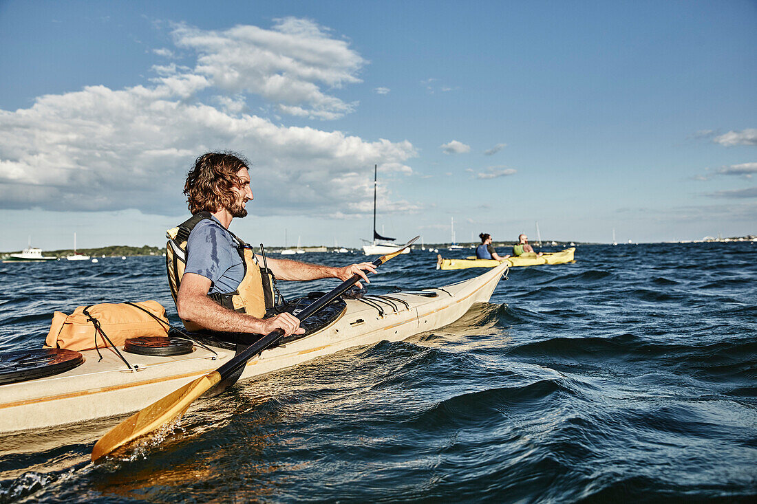 Photograph of kayak tour instructor explaining turning techniques for sea kayaking, Portland, Maine, USA