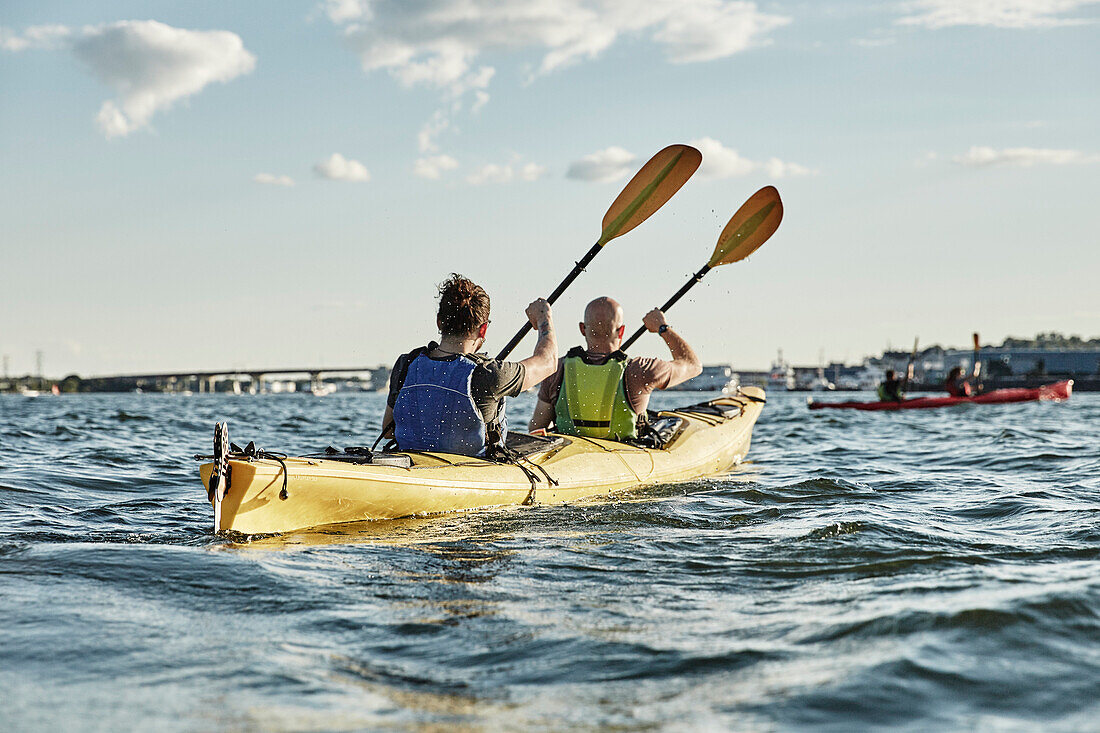 Photograph of two men paddling in tandem … – License image – 71183830 ...