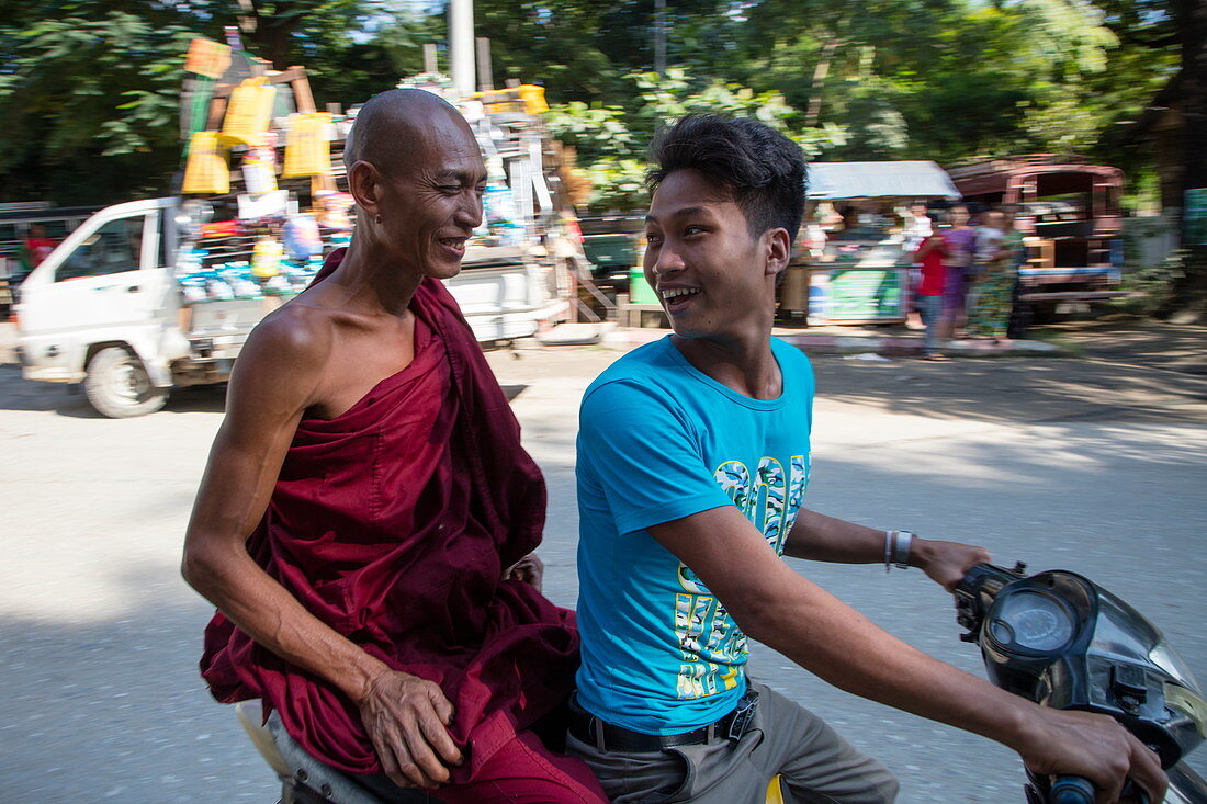 Young man and elderly Buddhist monk on motorbike, Mandalay, Mandalay, Myanmar