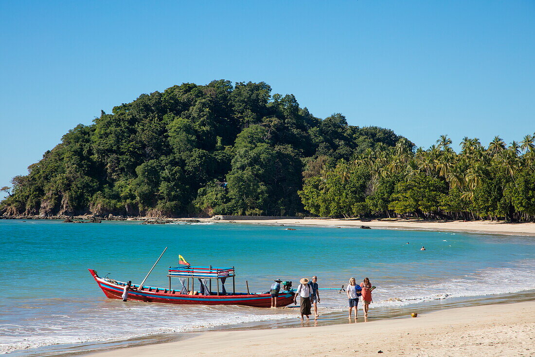 People disembark from boat after excursion to Maung Shwe Lay village, Ngapali, Thandwe, Myanmar