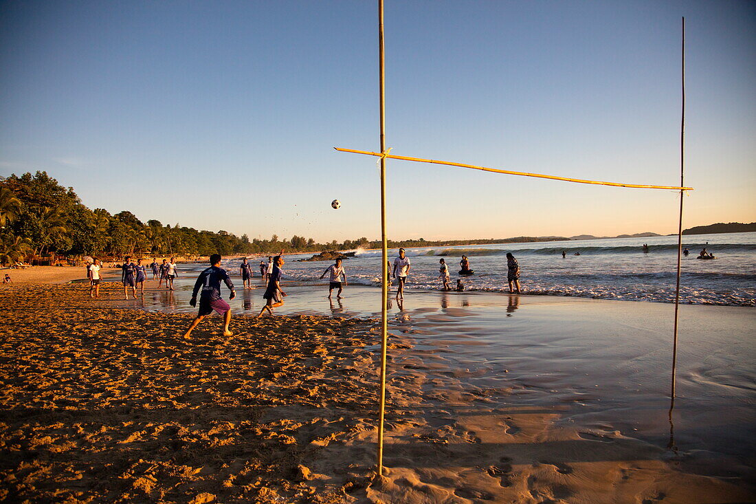 Young men play soccer during official league match on Ngapali beach, Ngapali, Thandwe, Myanmar