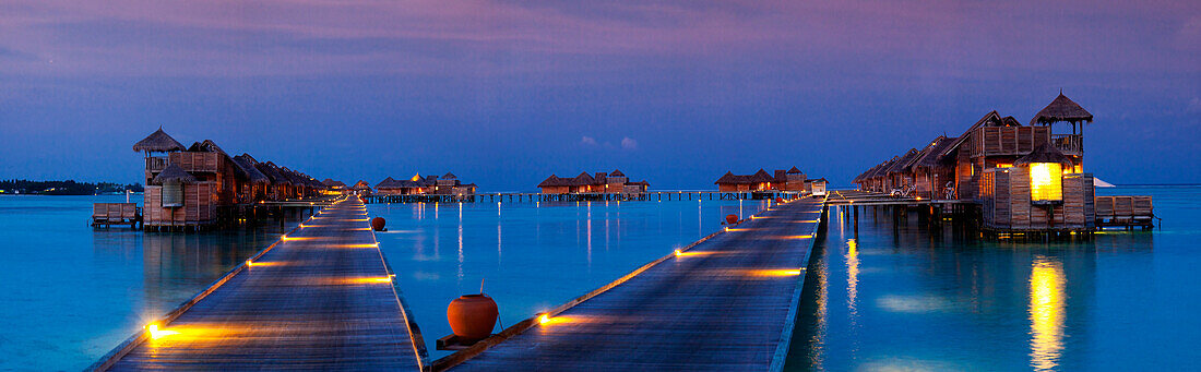 Panoramic view of evening lights in the villas at Gili Lankanfushi, Maldives.