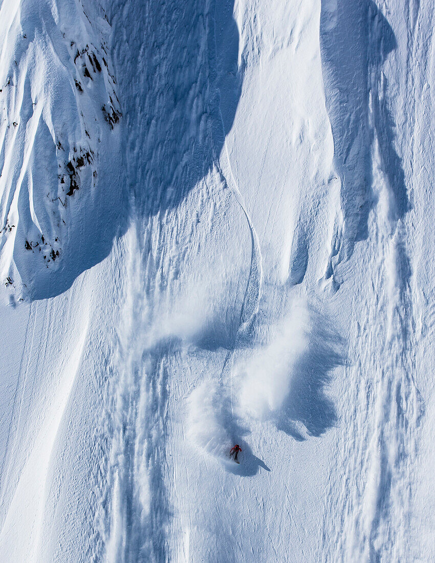 Professional snowboarder Marie France Roy, rides fresh powder on a sunny day while snowboarding in Haines, Alaska.