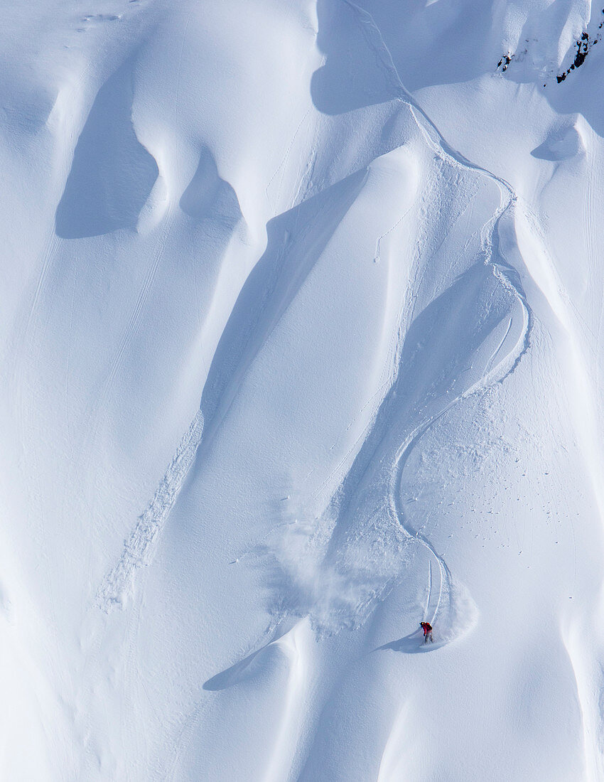 Professional snowboarder Marie France Roy, rides fresh powder on a sunny day while snowboarding in Haines, Alaska.