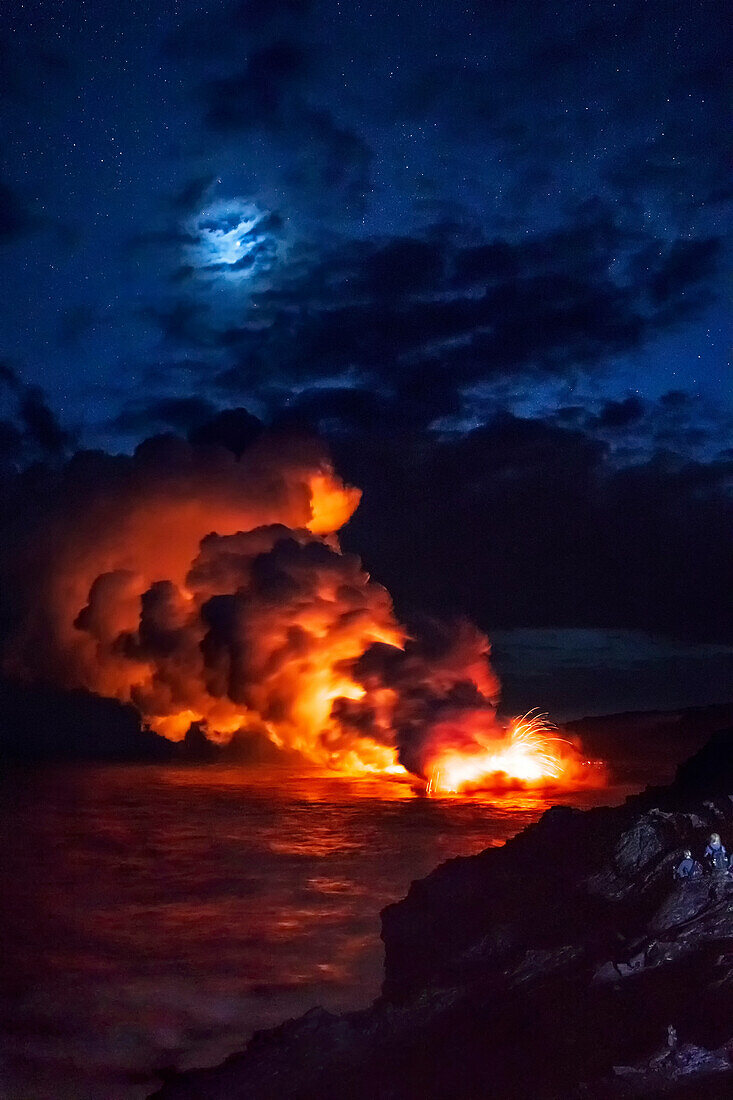 Tourists see lava from Kilauea volcano in the ocean at Kamokuna