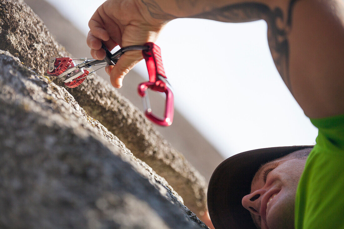 Climber putting cams while climbing