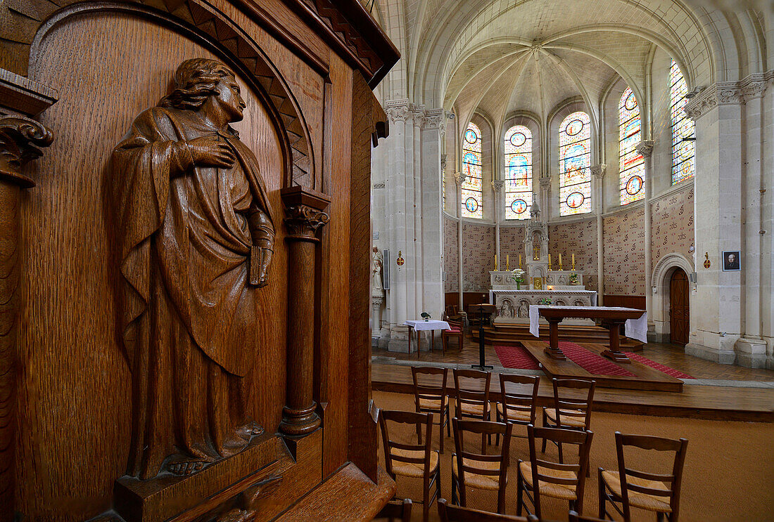 France, Western France, Vendee, Interior view of the Church of the Copechaniere. Wooden sculpture in the foreground. Choir and altar in the background