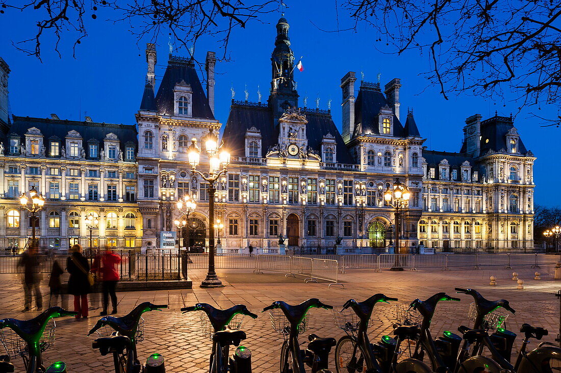 Frankreich, Paris, Hotel de Ville (Rathaus) bei Nacht, gemeinsame Fahrräder im Vordergrund