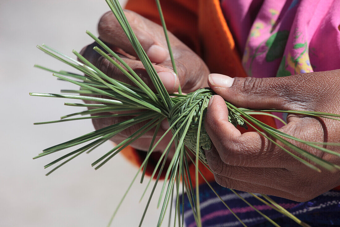 Mexico, Chihuahua State, Sierra Tarahumara, Creel, Tarahumara woman braiding a basketry