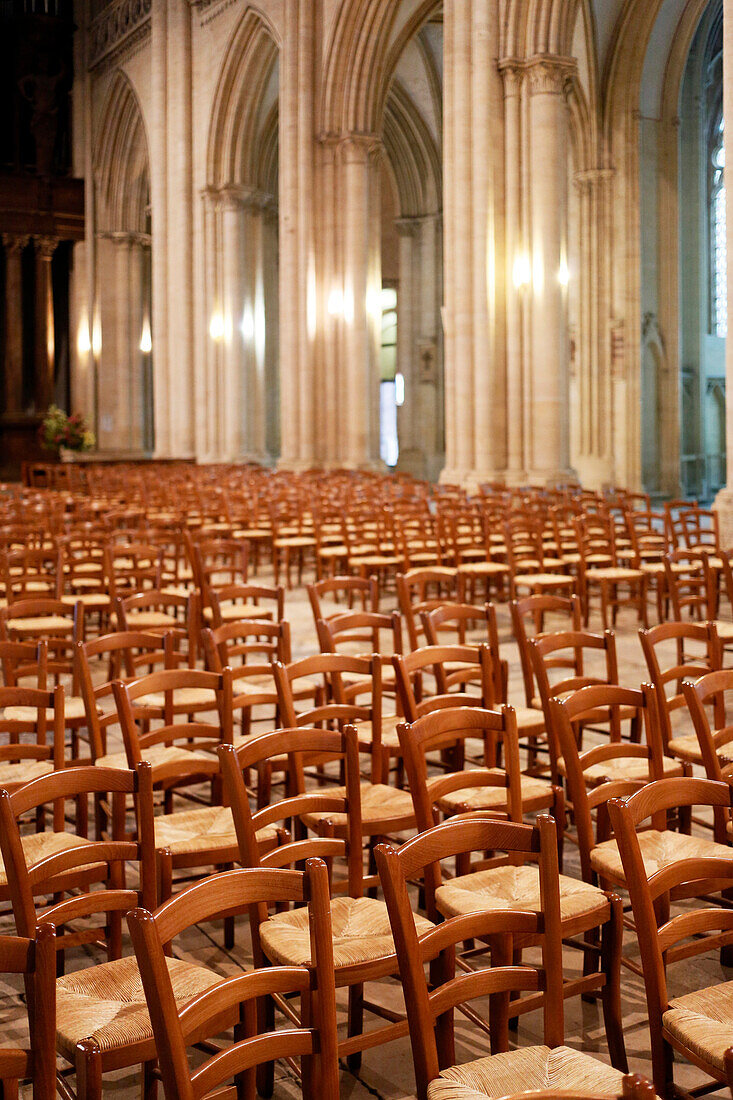 France, Normandy. Manche. Coutances. Deserted cathedral of Coutances. Alignment of empty chairs.