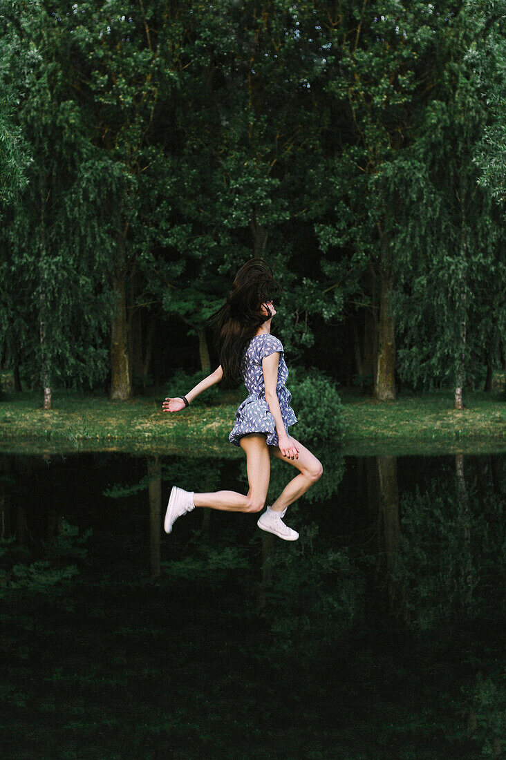 Caucasian woman floating over lake