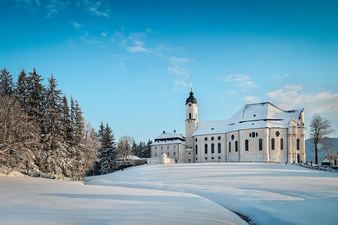 UNESCO World Heritage Wies Church, pilgrimage church surrounded by snow, Steingaden, Bavaria, Germany