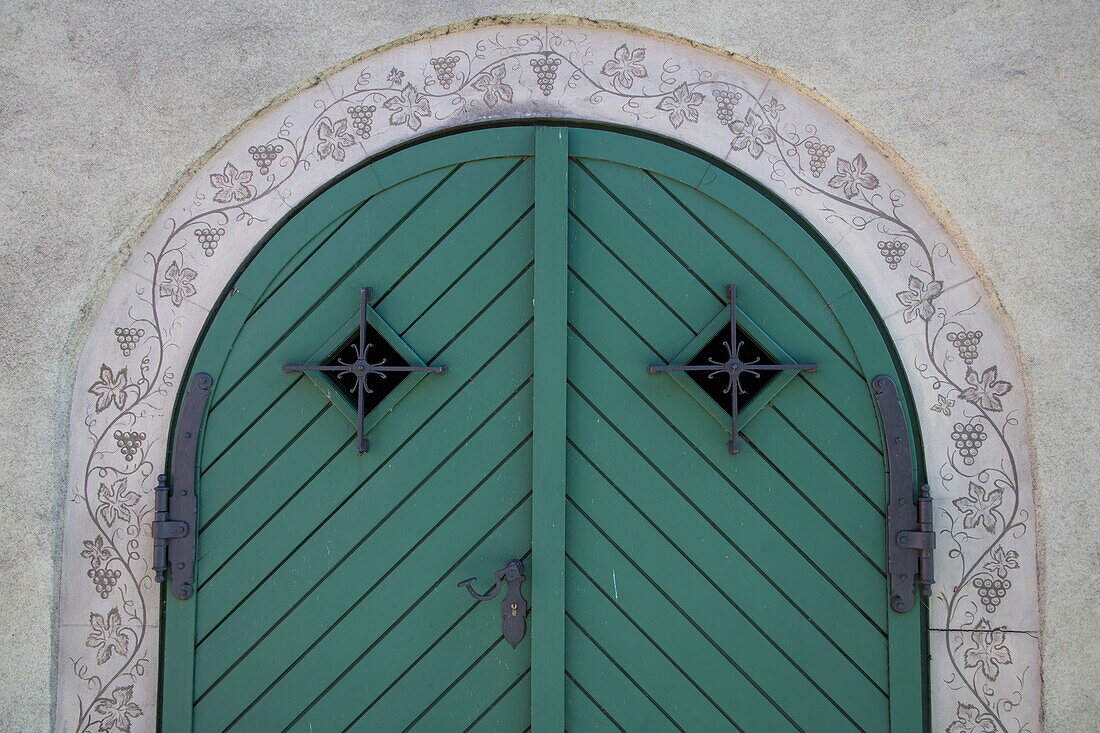 Green gate and wine motif decoration in Altstadt old town, Iphofen, Franconia, Bavaria, Germany