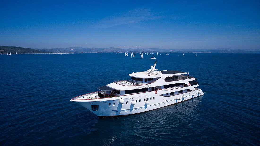 Aerial of cruise ship MS Romantic Star (Reisebüro Mittelthurgau) with sailboats during regatta in Adriatic Sea, near Trogir, Split-Dalmatia, Croatia