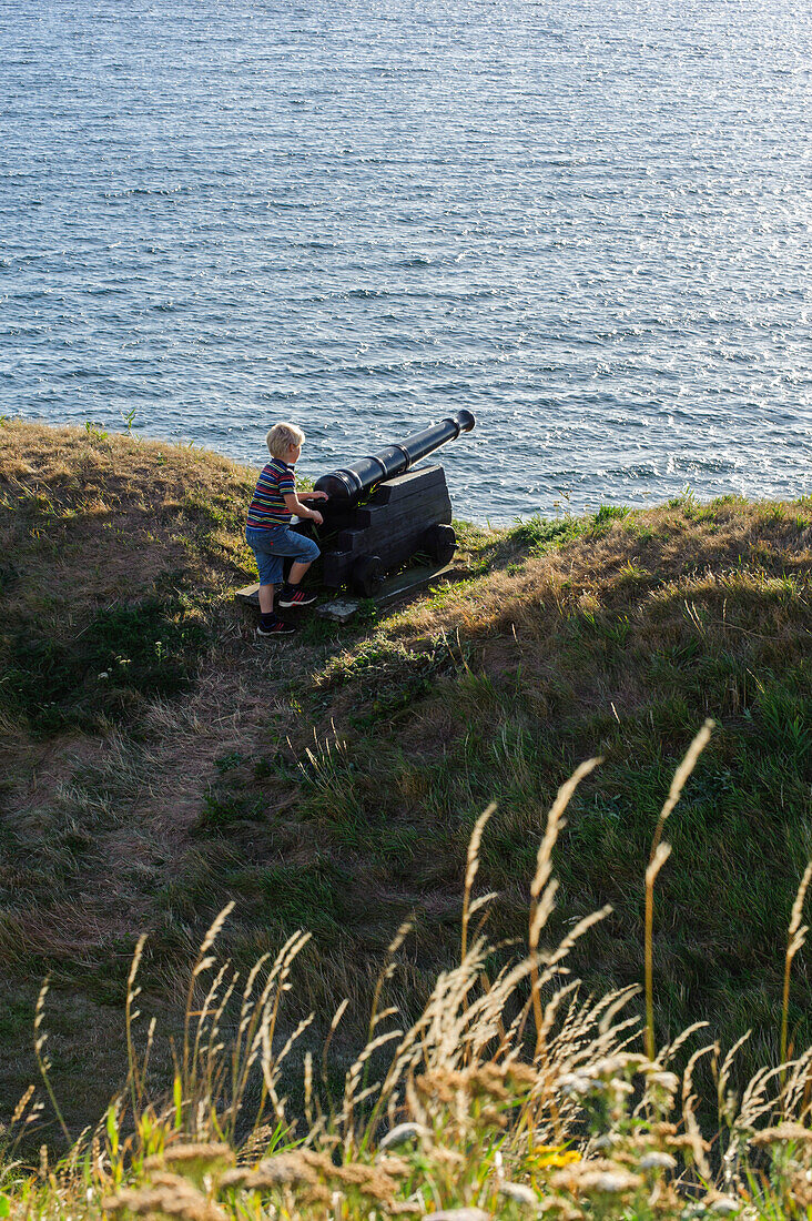 Cannon with blond boy on the fortress of Varberg, Sweden