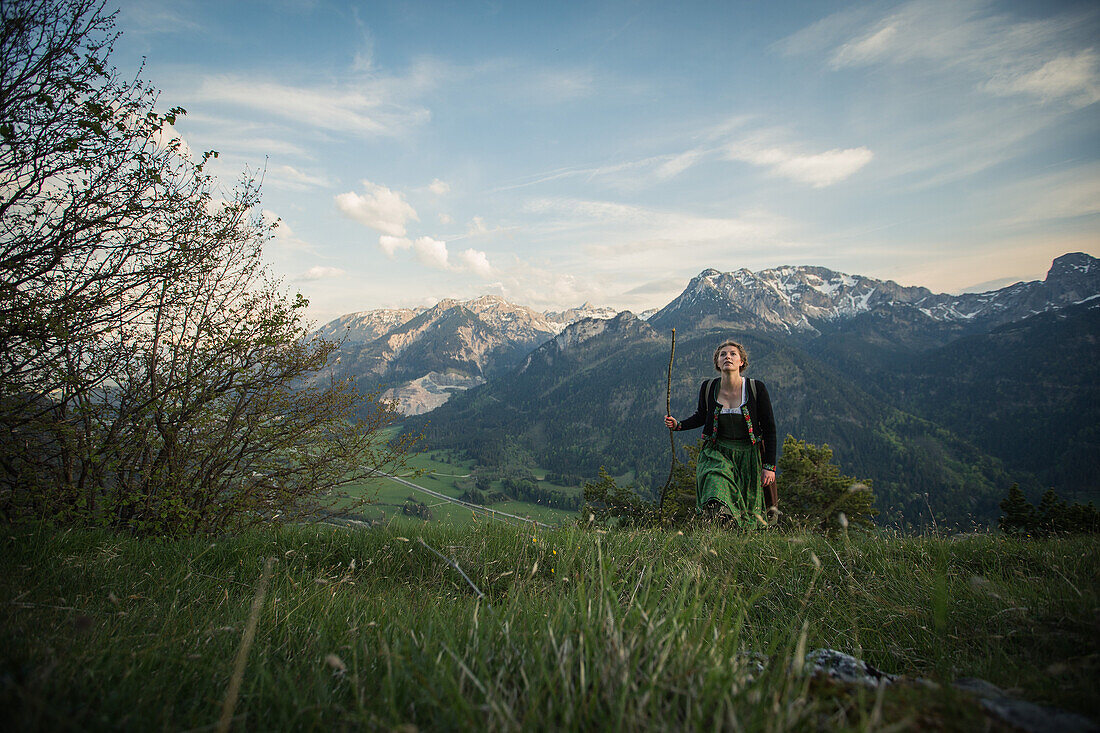 Young woman in traditional costume hiking on the Falkenstein in the Allgaeu, Pfronten, Bavaria, Germany