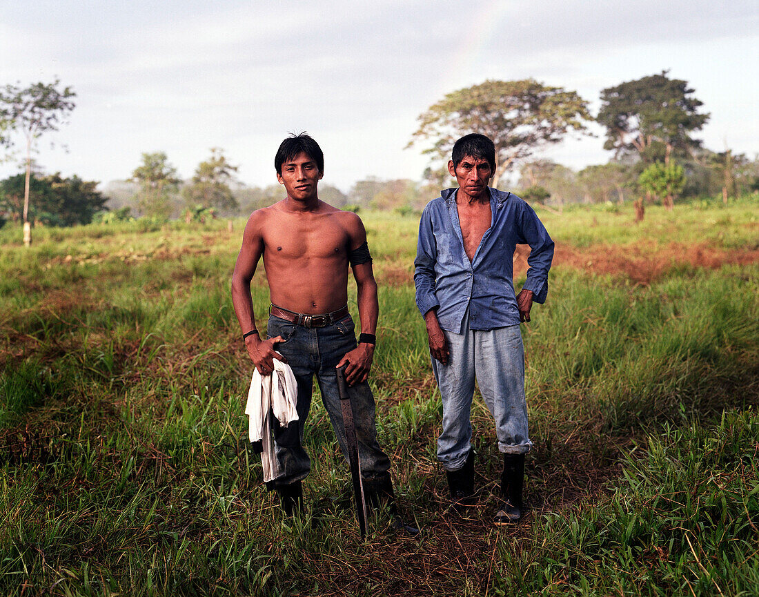 Hispanic men standing in field