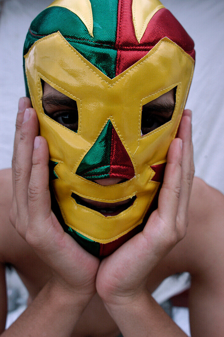 Hispanic man wearing wrestling mask