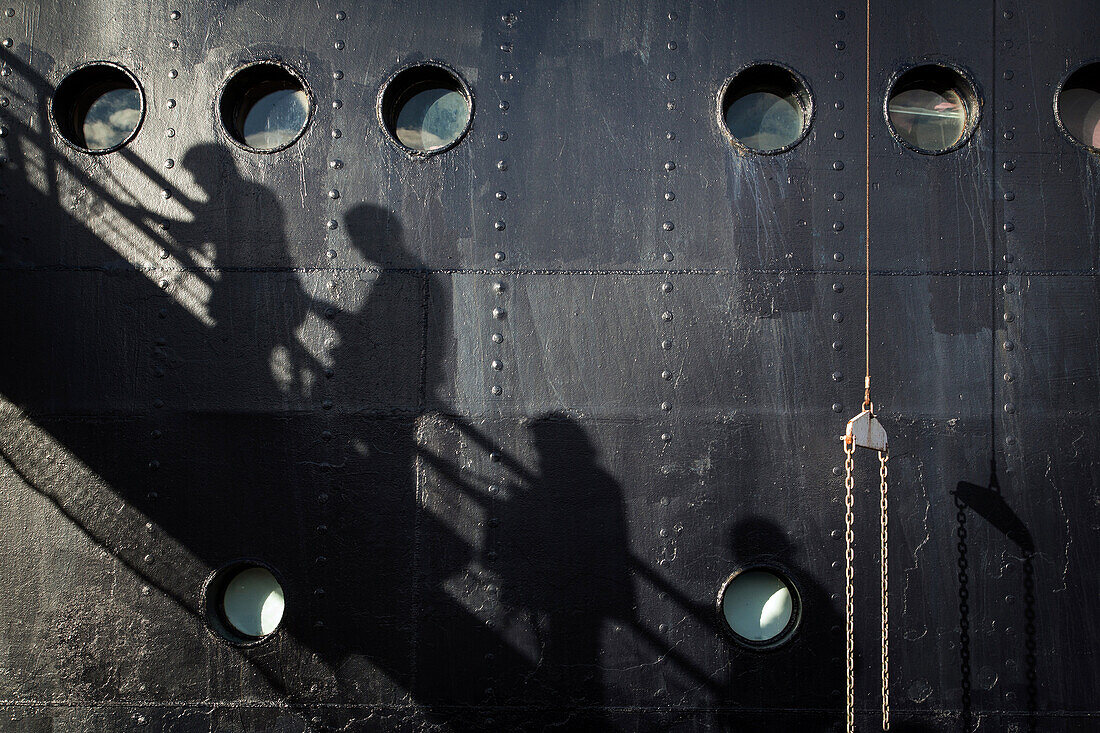shadow of the passengers on the the gangway for boarding the cruise ship astoria, greenland