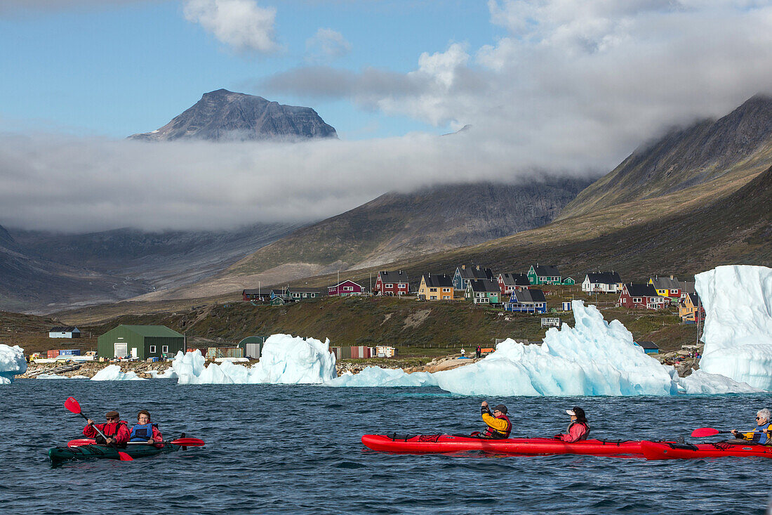 kayaking in the middle of the icebergs that separated from the glacier, fjord of narsaq bay, greenland