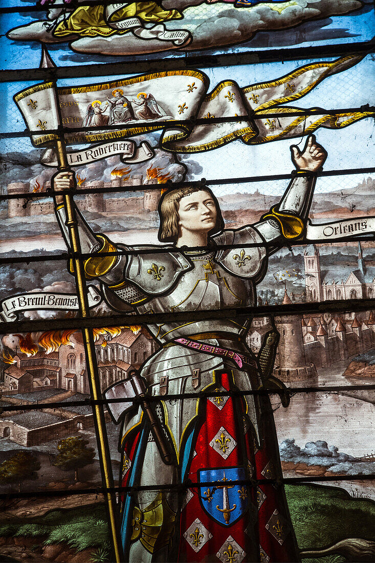 stained glass showing joan of arc in front of the burning abbey, the city of orleans and the chateau de la robertiere, breuil-benoit abbey, marcilly-sur-eure (27), france