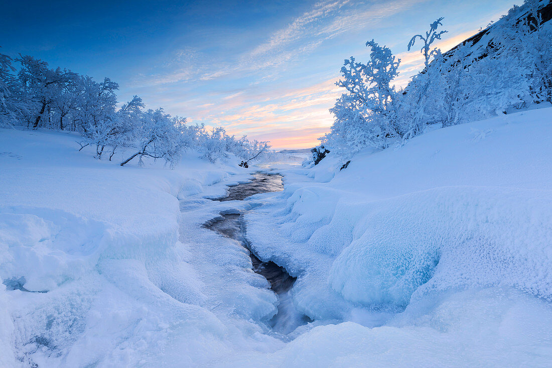 Sunrise on the frozen river and forest, Abisko, Kiruna Municipality, Norrbotten County, Lapland, Sweden, Scandinavia, Europe