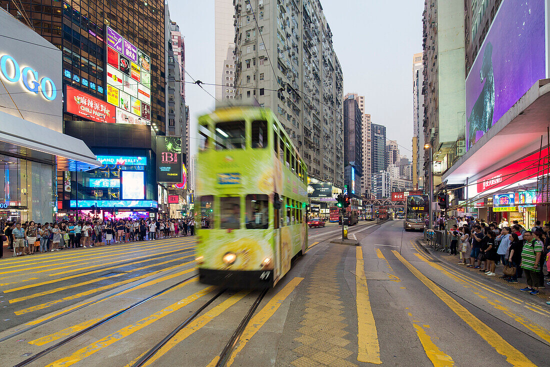 Pedestrians and traffic at a busy road crossing in Causeway Bay, Hong Kong Island, Hong Kong, China, Asia