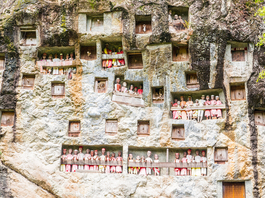 Galleries of tao-taos interspersed with the doors to family crypts, Tana Toraja, Sulawesi, Indonesia, Southeast Asia, Asia