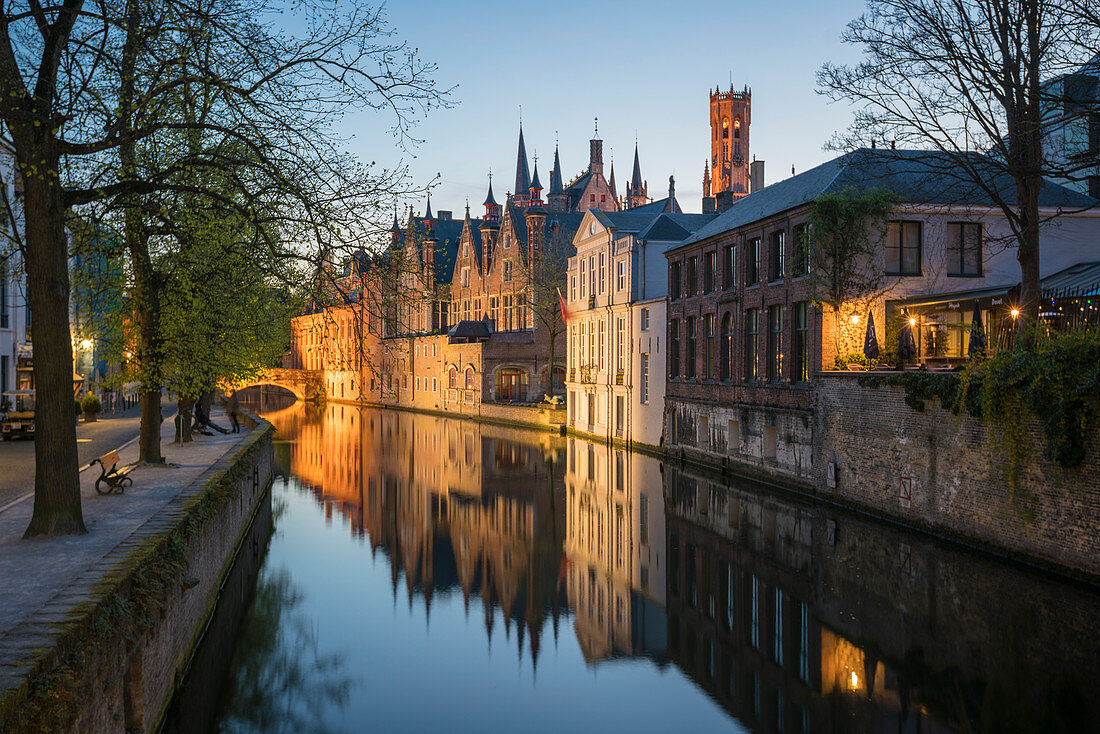 Houses and bridge reflected in the Groenerei canal at dusk, Bruges, West Flanders province, Flemish region, Belgium, Europe