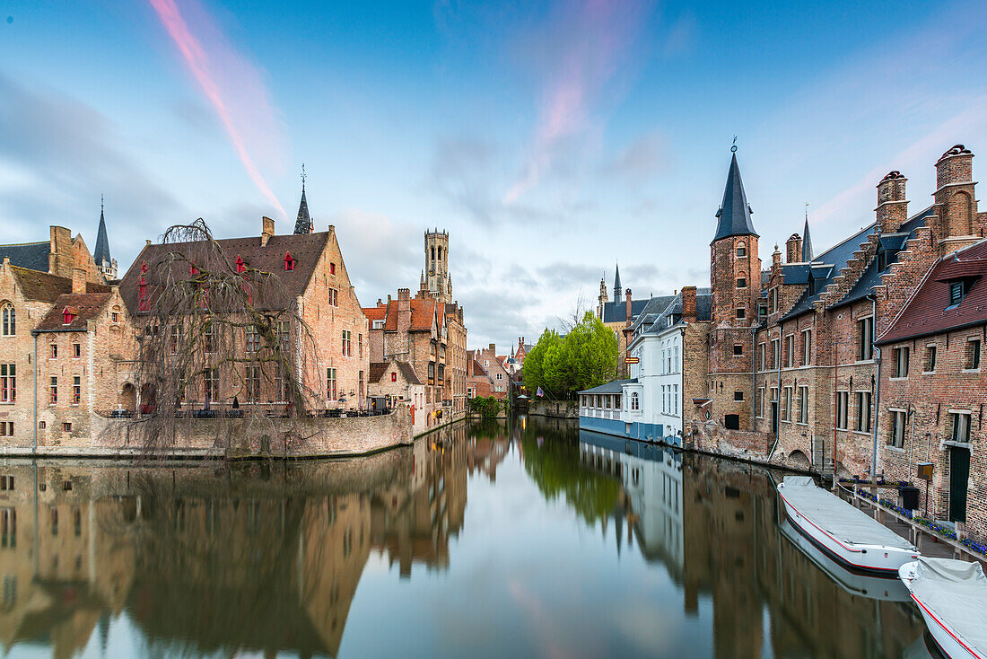 House reflections and boats on Dijver canal at dawn, Bruges, West Flanders province, Flemish region, Belgium, Europe