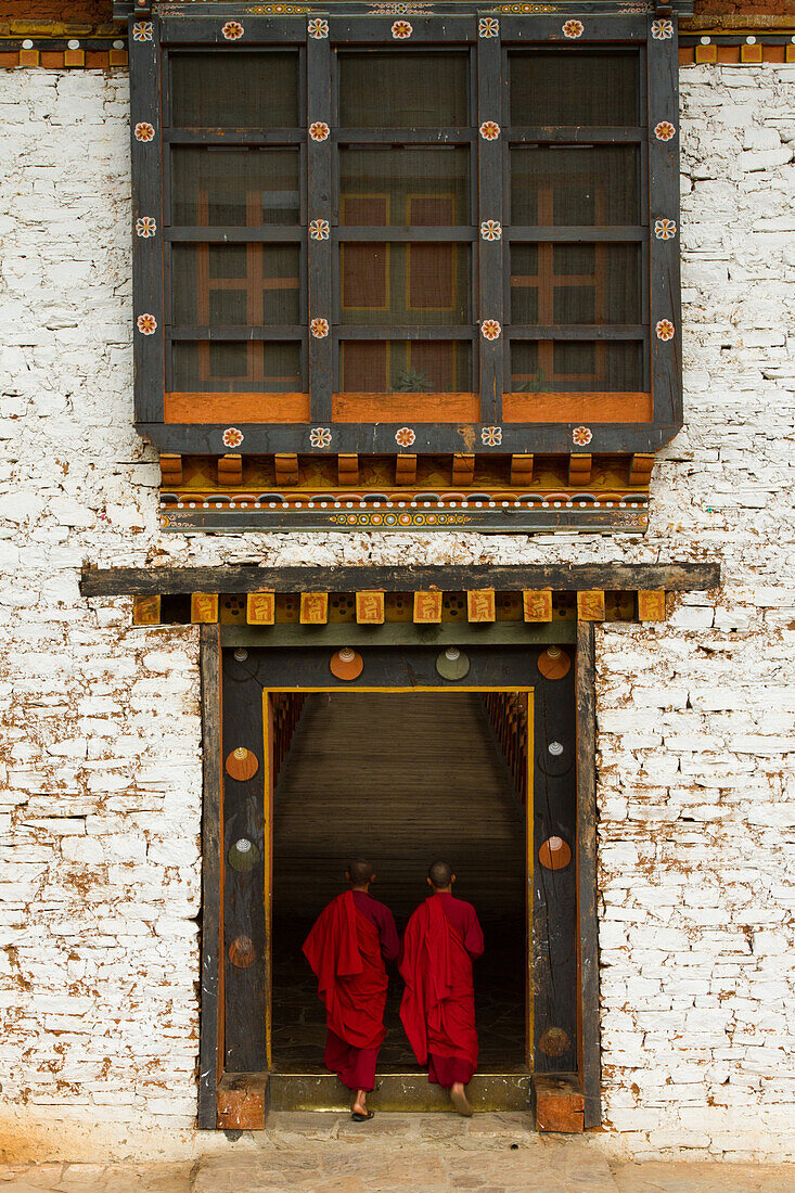The Punakha Fortress and Buddhist monks, Paro, Bhutan, Asia