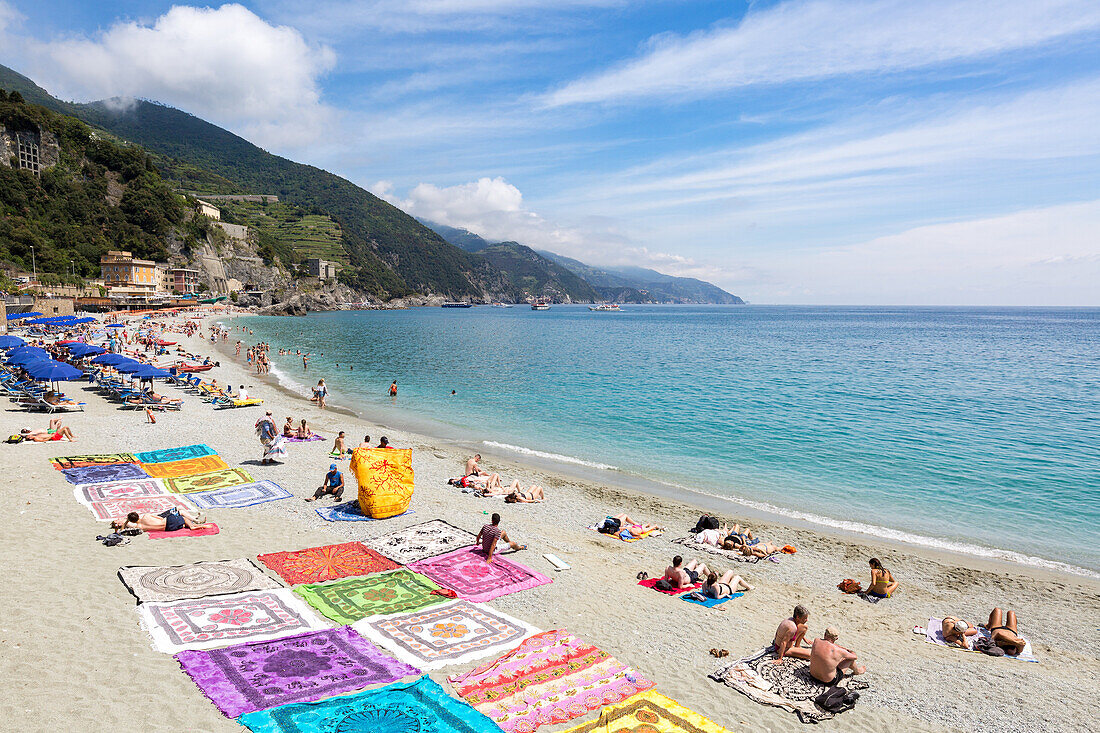 Blanket sellers showcasing their products on the beach at Monterosso, Cinque Terre, Liguria, Italy, Mediterranean, Europe