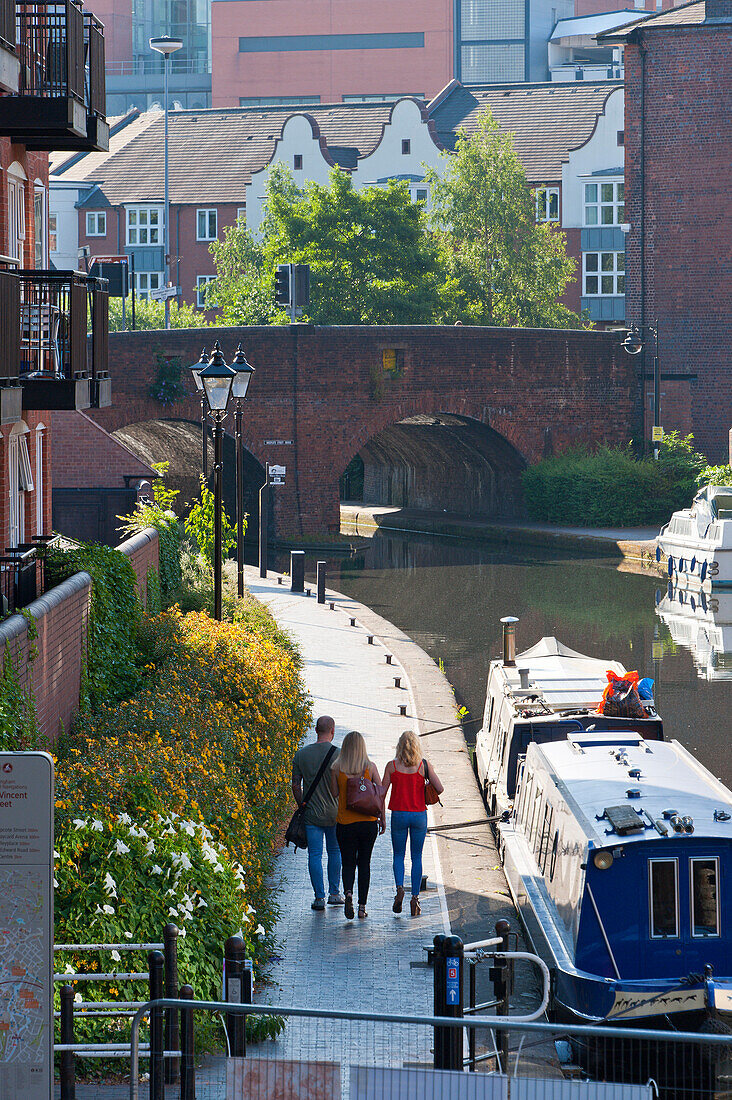People walk along a tow path by the canal in Birmingham, West Midlands, England, United Kingdom, Europe