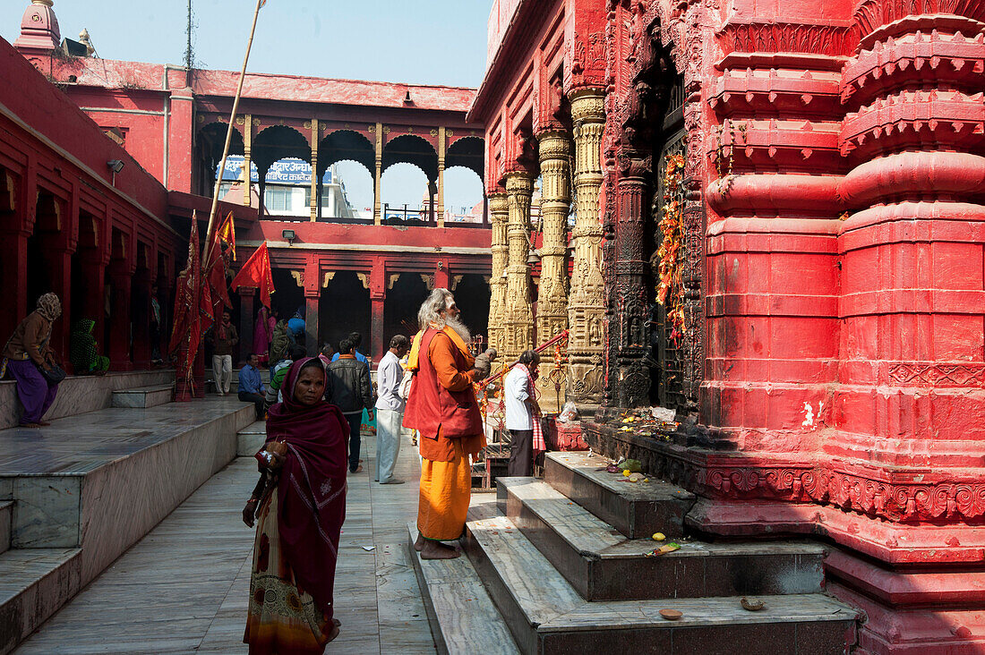 Hindu pilgrim dressed in saffron and red, visiting the Durga Mandir, one of the most famous temples in Varanasi, Uttar Pradesh, India, Asia